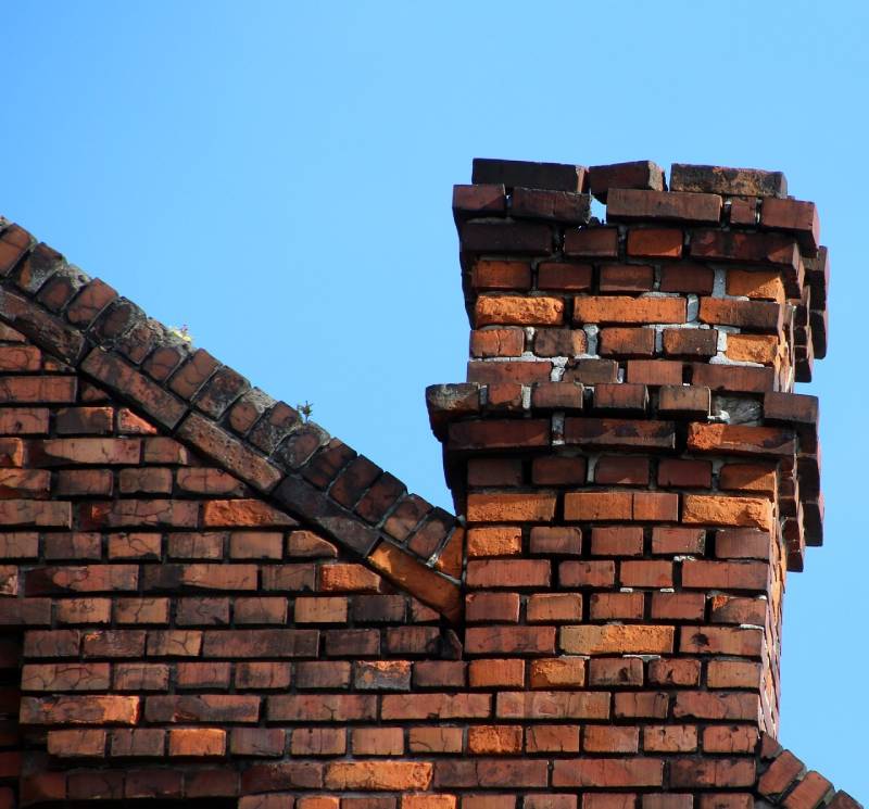 Signs Your Willowbrook Home Needs a Chimney Inspection Damaged chimney on an Willowbrook home showing cracks and missing mortar